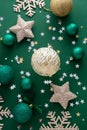 Christmas background with winter decorations, stars, baubles over green background Royalty Free Stock Photo