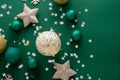 Christmas background with winter decorations, stars, baubles over green background Royalty Free Stock Photo