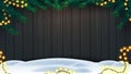 Christmas background, wooden fence of boards with frame of Christmas tree branches, garland of yellow bulb lights and snow.