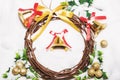 Christmas background, Wreath woven from the branch of the vine with golden bells and green leaf Royalty Free Stock Photo