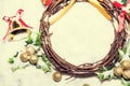 Christmas background, Wreath woven from the branch of the vine with golden bells and green leaf, vintage tone Royalty Free Stock Photo