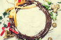 Christmas background, Wreath woven from the branch of the vine with golden bells and green leaf, vintage tone Royalty Free Stock Photo