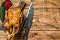 Christmas Baked whole goose with herbs. wooden background. Top view. Space for text