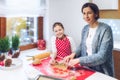 Christmas bakery. Mother and daughter making gingerbread, cutting cookies of gingerbread dough.