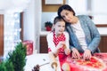 Christmas bakery. Mother and daughter making gingerbread, cutting cookies of gingerbread dough. Royalty Free Stock Photo