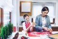 Christmas bakery. Mother and daughter making gingerbread, cutting cookies of gingerbread dough. Royalty Free Stock Photo