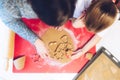 Christmas bakery. Mother and daughter making gingerbread, cutting cookies of gingerbread dough, view from above. Royalty Free Stock Photo