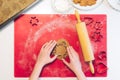 Christmas bakery. Woman making gingerbread,cutting cookies of gingerbread dough, view from above Royalty Free Stock Photo