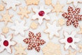 Christmas baking background with a variety of snowflake cookies on white marble