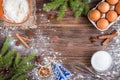 Christmas baking of ginger cookies on dark wooden background with fir branches