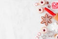 Christmas baking side border with cookies and sweets. Overhead view over a white marble background.