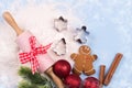 Spilled flour, cookie cutters, rolling pin, spices, smiling gingerbread man, christmas red decorations, pine branches Royalty Free Stock Photo