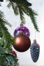 Christmas ball on the background of blurred glass with frost and colored lights with the falling snowflakes Royalty Free Stock Photo