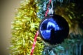 Christmas ball. On a background of golden tinsel blue ball