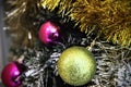 Christmas ball. On a background of golden tinsels gold and pink ball