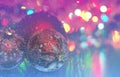 Christmas ball close-up on the background of lanterns blurred by a purple and blue background and running snow. Royalty Free Stock Photo