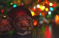 Christmas ball close-up on the background of the lights garland blurred purple and blue background.