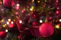 Christmas ball on a decorated Christmas tree with a garland of lights. Color of 2023, Viva Magenta Royalty Free Stock Photo