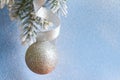 Christmas ball on fir branches and snowy blue background