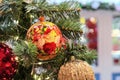 Christmas ball with floral ornament on Christmas tree with garland. Handmade Christmas decorations Royalty Free Stock Photo