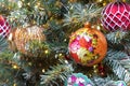 Christmas ball with floral ornament on Christmas tree with garland. Handmade Christmas decorations Royalty Free Stock Photo