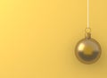 Christmas ball gold ornament hanging on yellow background. Holiday concept, new year. Minimal concept idea.