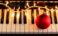 Christmas ball and lights on a piano keyboard, above view Royalty Free Stock Photo