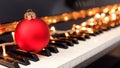 Christmas ball and lights on a piano keyboard Royalty Free Stock Photo