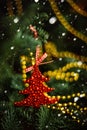 Christmas ball in shape of strawberry on a snow-covered tree branch. Red toy with frost and snowflakes. Selective focus Royalty Free Stock Photo