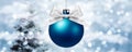 Christmas ball with silver ribbon bow on blurred lights Royalty Free Stock Photo