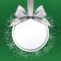 Christmas ball with silver satin ribbon bow on green Royalty Free Stock Photo