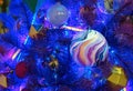 Christmas ball in space style on a Christmas tree with blue neon backlights Royalty Free Stock Photo