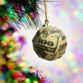 Christmas ball wrapped in a banknote Royalty Free Stock Photo