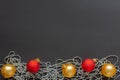 Christmas balls and beads on black background Royalty Free Stock Photo