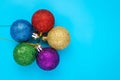 Christmas balls on blue background. New year card with shiny colorful spheres, copy space. Royalty Free Stock Photo