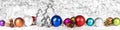 Christmas balls, cones and fir trees in front of white shiny background Royalty Free Stock Photo