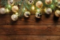 Christmas balls decoration in vintage style and fir tree branches with lights on old wooden background. Flat lay, top view. Royalty Free Stock Photo