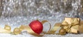 Christmas balls and gift box, golden ribbon and snow, abstract bokeh lights background Royalty Free Stock Photo