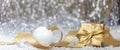 Christmas balls and gift box, golden ribbon and snow, abstract bokeh lights Royalty Free Stock Photo