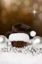 christmas balls, pointed hat and pearls, festive brown background with stars