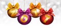 Christmas balls with ribbon and golden 2017 text on blurred