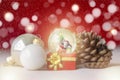 Christmas balls, Santa Claus in a Snow globe, and Pine cones on a Cream-Colored Cloth, set Against a Red Background and exquisite Royalty Free Stock Photo