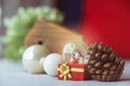 Christmas balls, Santa Claus in a Snow globe, and Pine cones on a Cream-Colored Cloth, set Against a Red Background and exquisite Royalty Free Stock Photo