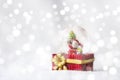 Christmas balls, Santa Claus in a Snow globe, and Pine cones on a white Cloth, set Against a Red Background and exquisite bokeh. Royalty Free Stock Photo