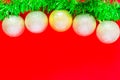 Christmas balls of silver color hang on a green fluffy garland tinsel Royalty Free Stock Photo