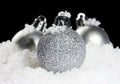 Christmas balls with snow on black background Royalty Free Stock Photo