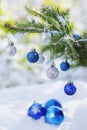 Christmas balls on the snow and branch of Christmas tree outdoor Royalty Free Stock Photo
