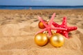 Christmas balls with starfish on beach Royalty Free Stock Photo