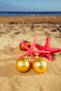 Christmas balls with starfish on beach Royalty Free Stock Photo