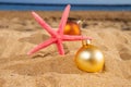 Christmas balls with starfush on beach Royalty Free Stock Photo